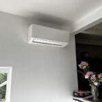 Wall-mounted Mitsubishi ductless AC system installed in a San Diego home by American Comfort Services, the best HVAC contractor in San Diego.